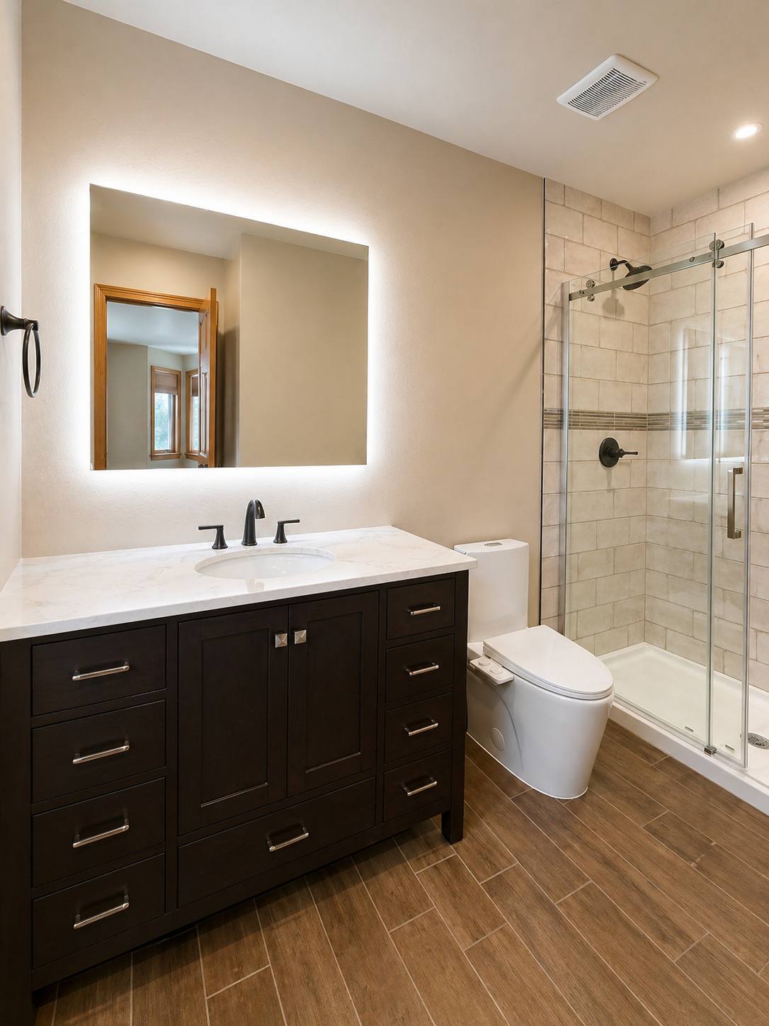 Bathroom with dark vanity and glass shower