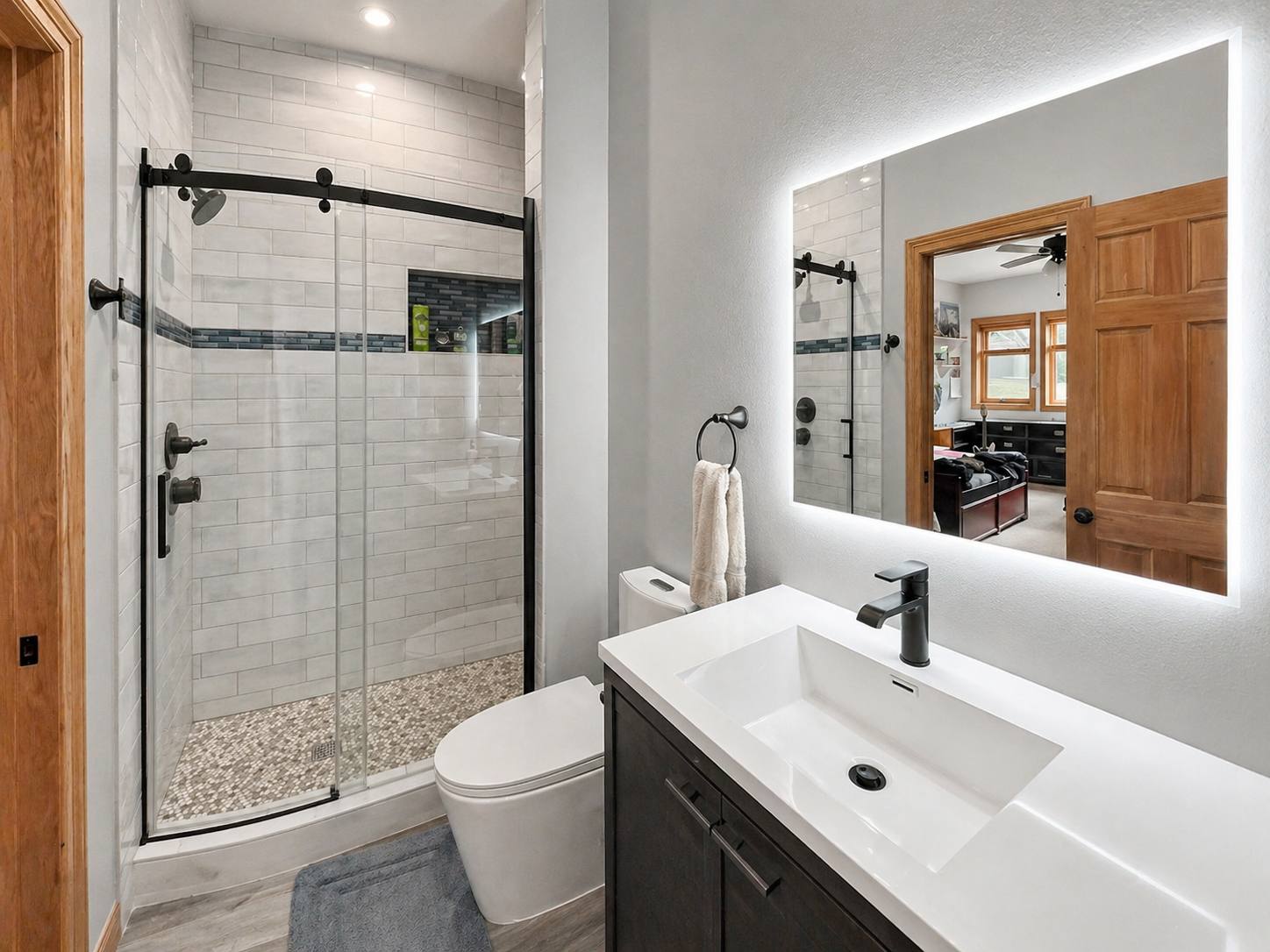 Glass-enclosed shower with tile surround