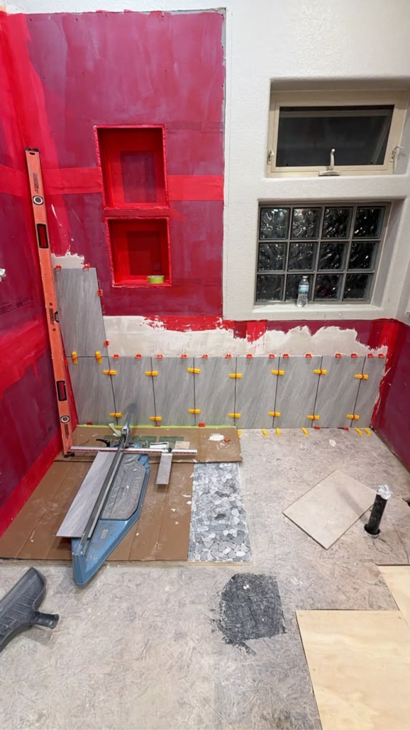 Liquid-applied waterproofing membrane over shower walls and niches before tiling