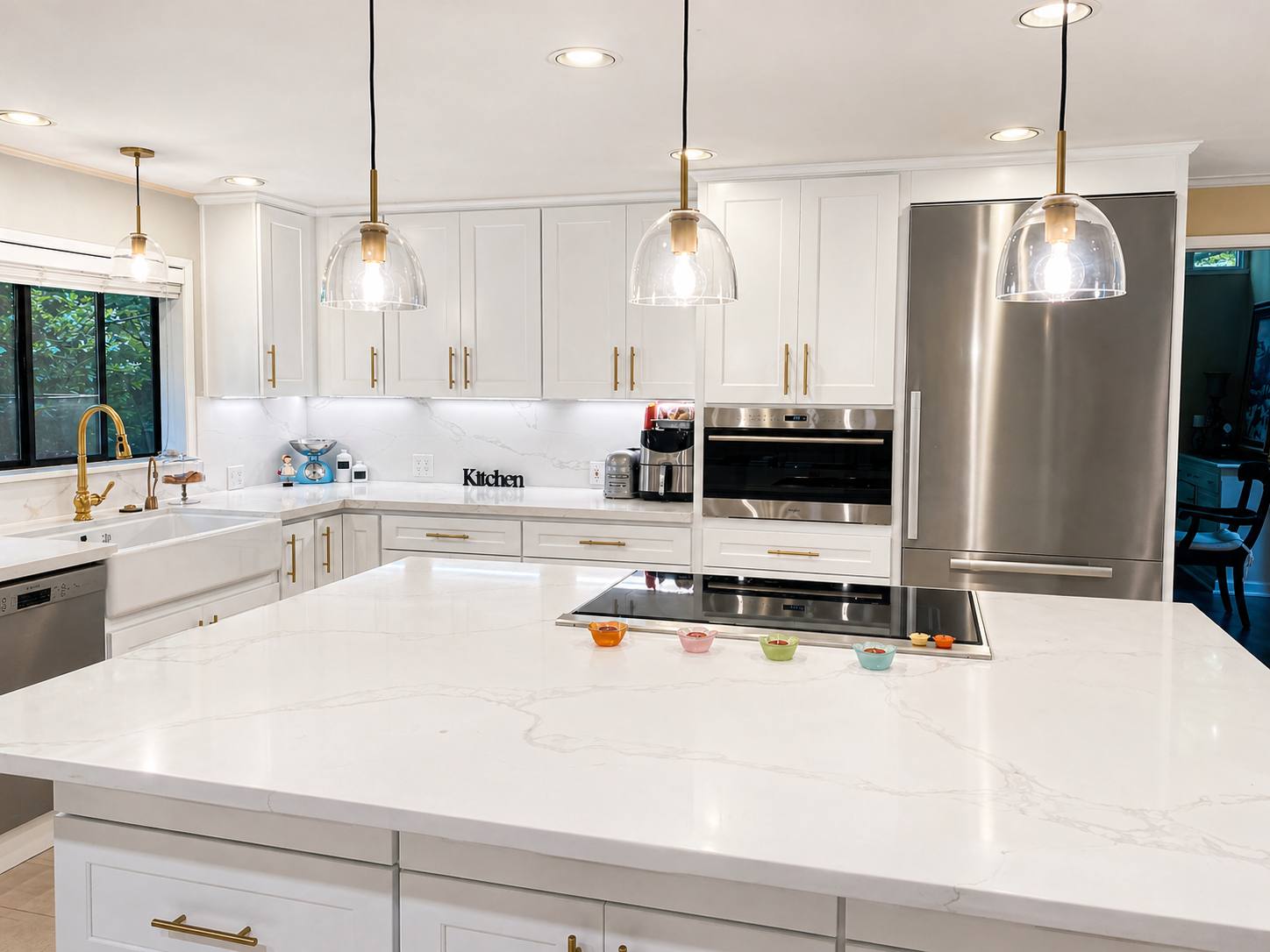 White kitchen with large island and cooktop
